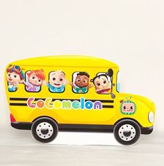 a yellow toy bus with cartoon characters on it's side and the words cocomelon painted on the front