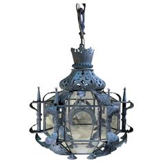 an old fashioned hanging lantern with a crown on top