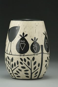 a black and white vase with birds on it