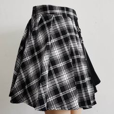 Add a direct touch of punk and gothic style to your wardrobe with the high-waist punk asymmetric cutout pleated skirt! This above-the-knee skirt is designed for those who want to take risks and push fashion boundaries. The high-waist design ensures an effortlessly chic look, while the bold cutouts offer an eye-catching detail that cannot be ignored. Plus, the irregular pleating on one side creates a unique texture and shape to help you stand out. And with its 2 silver-tone chains making a daring Gothic Pleated Skirt For Alternative Fashion, Mini Pleated Skirt For Streetwear, Black Gothic Pleated Skirt, Gothic Pleated Mini Skirt, Grunge Pleated Skirt For Alternative Fashion, Punk Style Black Pleated Skirt, Gothic High Waist Pleated Mini Skirt, Emo Skirt For Cosplay, Punk Streetwear Mini Skirt