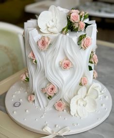 a white cake with pink flowers on it