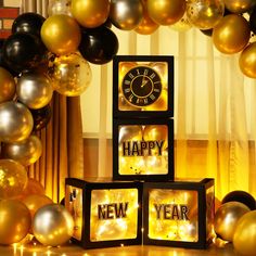 there is a clock that says happy new year and balloons in the air behind it