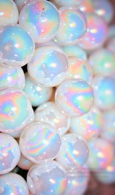 soap bubbles with iridescent colors are piled on top of each other in this close up photo