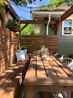 a wooden table sitting on top of a patio