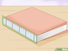 an open book sitting on top of a wooden table with green dots around the pages