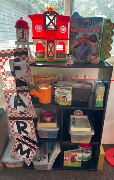 a shelf filled with lots of toys next to a window