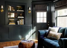 a living room filled with furniture and bookshelves