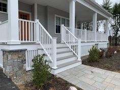 a white porch with steps leading up to it