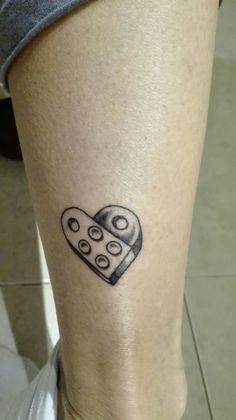 a tattoo on the leg of a person with a heart shaped piece of food in it