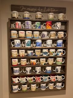 a wooden shelf filled with lots of coffee mugs