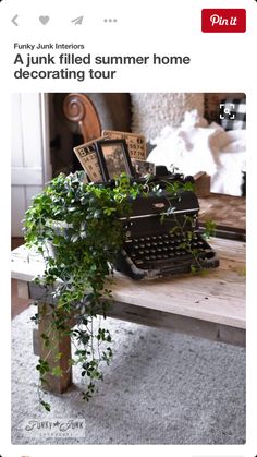 an old fashioned typewriter sitting on top of a table next to a potted plant