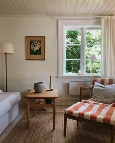 a living room filled with furniture next to a window