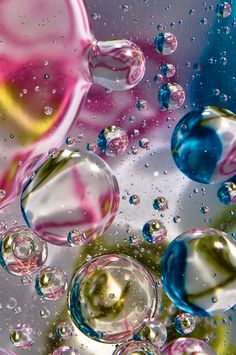 colorful bubbles are floating in the water