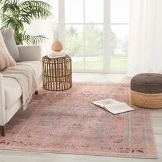 a living room with a couch, chair and rug in front of a large window