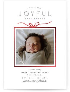 a baby's birth announcement with a red ribbon