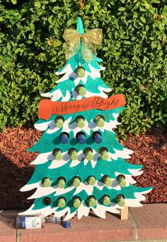 a christmas tree made out of wine bottles with a bow on it's head