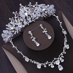 a tiara and earring set on top of a table