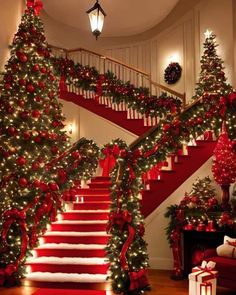 christmas decorations on the stairs and staircases are decorated with red ribbons, bows, and lights