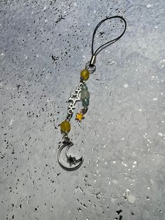 a keychain with beads hanging from it's side on the snow covered ground