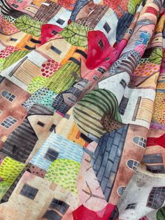 a multicolored quilt with houses on it