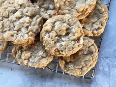 a bunch of cookies sitting on top of a cooling rack