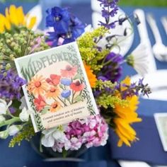 a vase filled with flowers sitting on top of a table covered in blue and white plates