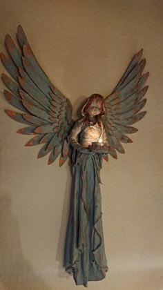 an angel statue is hanging on the wall