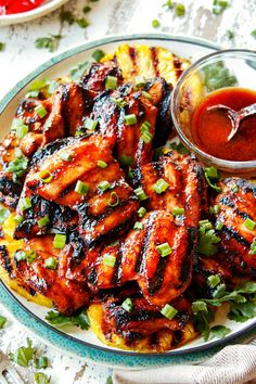 grilled chicken wings on a plate with ketchup and garnishes