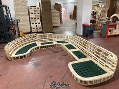 a wooden bench made out of pallets in a warehouse