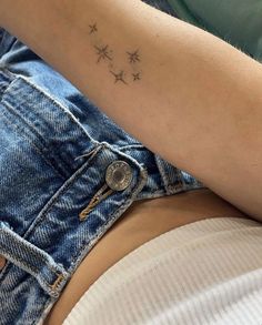 a woman with a small star tattoo on her arm