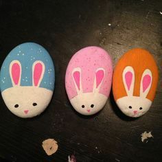 three painted rocks with bunny ears on them