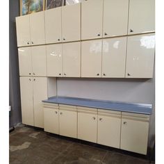 an empty room with many cabinets and cupboards