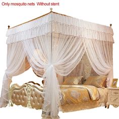 a white canopy bed sitting next to a night stand