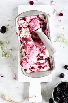 a pan filled with ice cream and blackberries