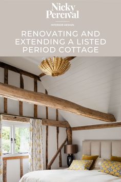 a white bed sitting under a wooden beam