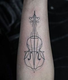 a violin tattoo on the arm