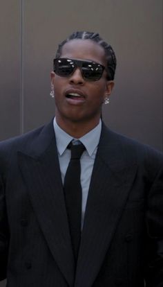 a man in a suit and tie wearing sunglasses