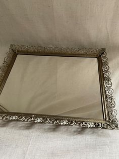 a mirror sitting on top of a white sheet