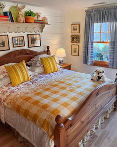 a bed with yellow and white comforter in a bedroom next to two lamps on either side of the bed