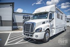 a white truck parked in front of a building