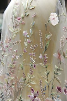 the back of a dress with flowers on it