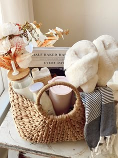 a basket filled with lots of items sitting on top of a table next to a window