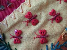 some pink buttons are sitting on a piece of fabric