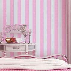 a bedroom with pink and white striped walls