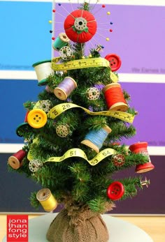 a small christmas tree decorated with buttons and ribbons