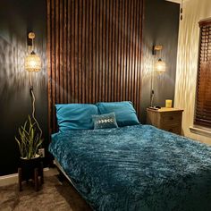 a bed room with a neatly made bed and wooden slats on the headboard