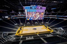 an empty basketball court in the middle of a stadium