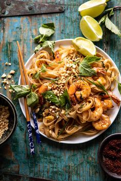 a white plate topped with pasta and shrimp