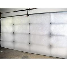 a white garage door with metal bars on it