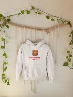 // d e s c r i p t i o n // Université Laval cozy go-to college hoodie/sweatshirt to curl up in. The garment is soft and smooth. Université Laval is a great University in Quebec, Canada. * Unisex fit * Washer and dryer safe * cotton & polyester (50/50) * Eco-friendly * Double-lined hood * Front pouch pocket // s i z i n g // For a looser fit: Your usual size Fitted look: One size down Measurements: Length / Width (inches) S: 27 / 20 M: 28 / 22 L: 29 / 24 XL: 30 / 26 2XL: 31 / 28 3XL: 32 / 30 // Strong Girl, Mom Hoodies, College Hoodies, College Sweatshirt, Anime Shirt, White Hoodie, Nurse Gifts, Cat Mom, Engagement Gifts